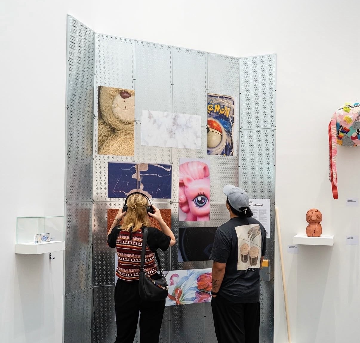 Two visitors looking at the Studio Woensel West wall of nostalgic photos at the Van Abbe Museum