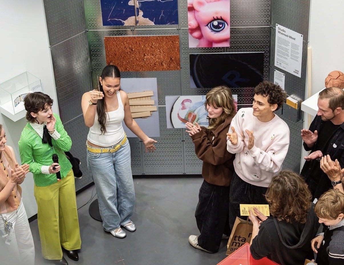 Coralie presenting at the installation opening while the group applauds