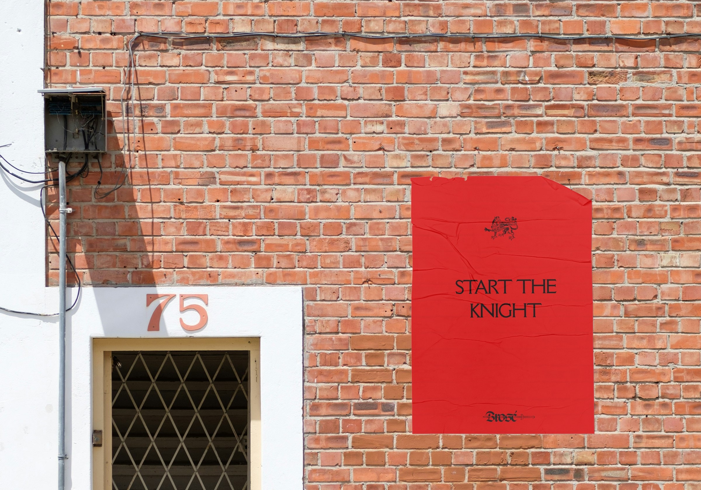 Red Start the Knight poster pasted on a brick wall