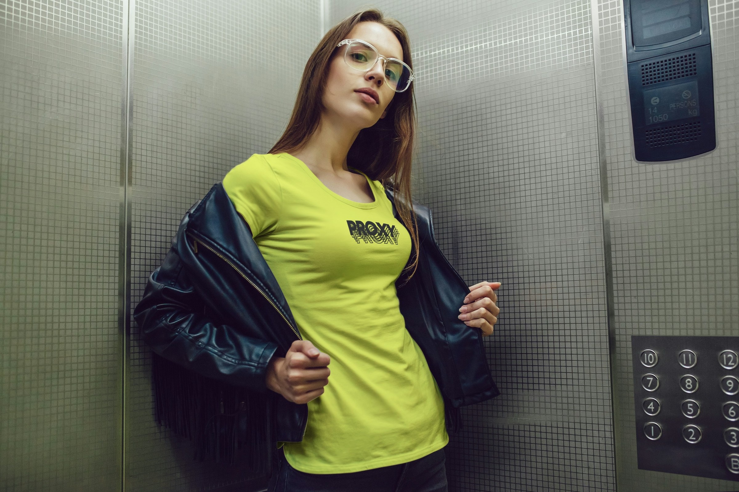 Woman in a lift wearing the lime green Proxy shirt