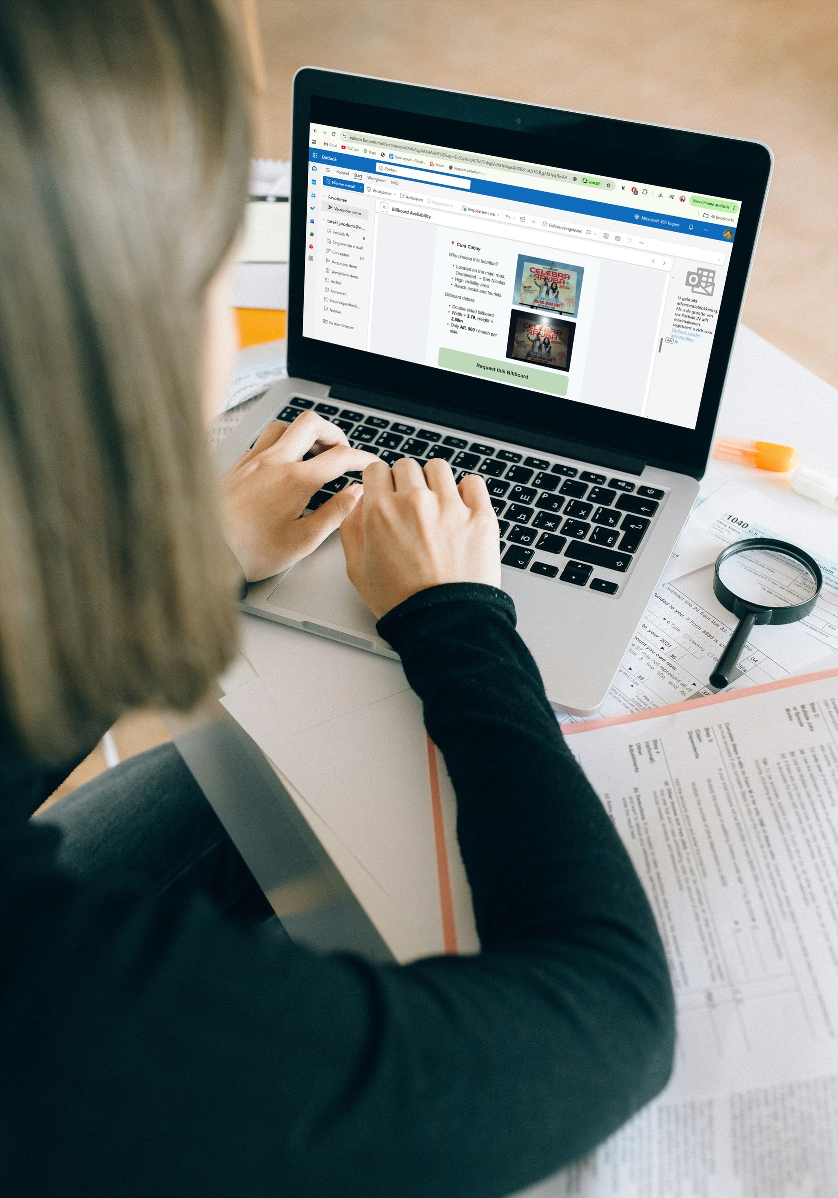 Woman reading the billboard availability email in Outlook on a laptop