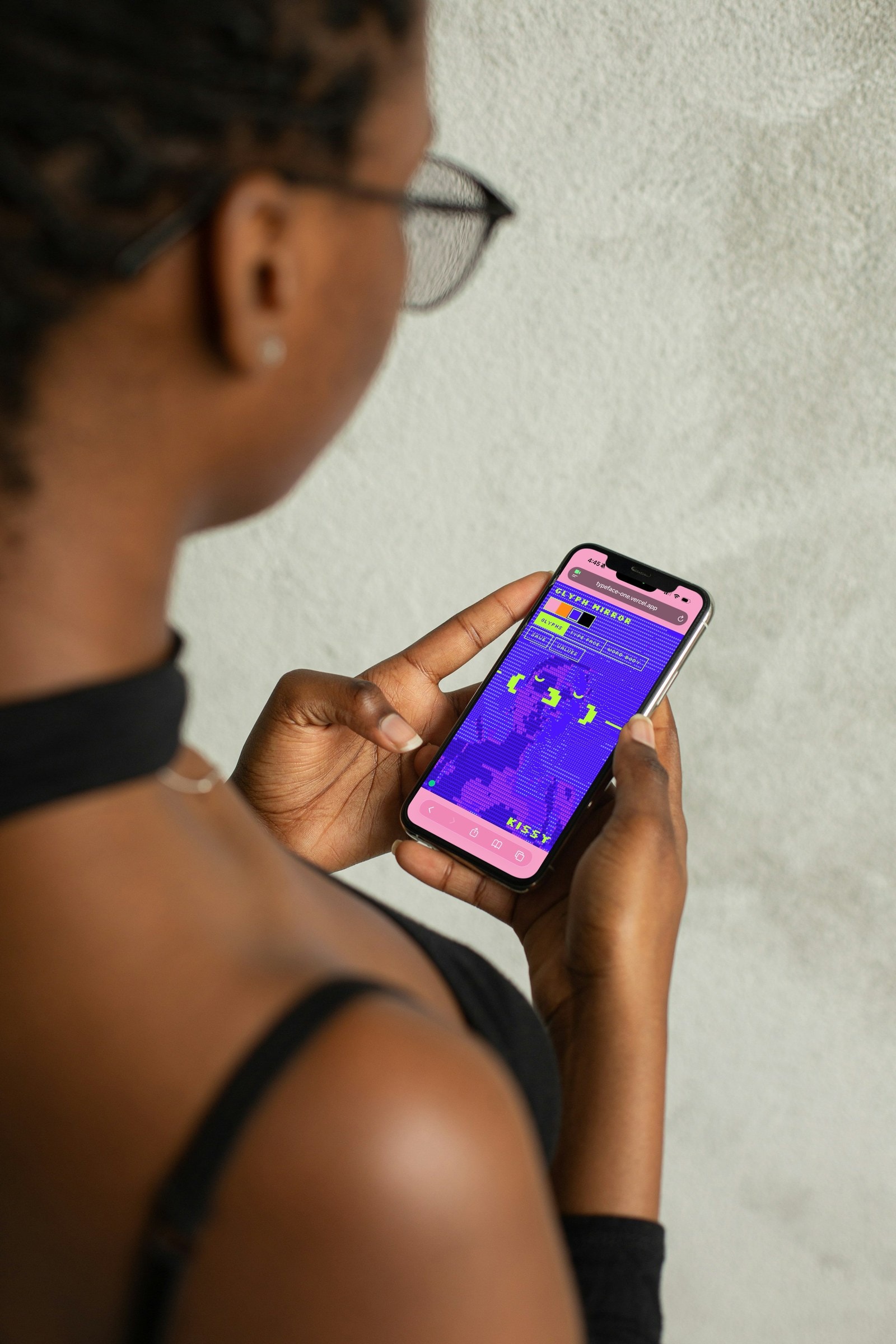 Woman with glasses using the Glyph Mirror website on her phone